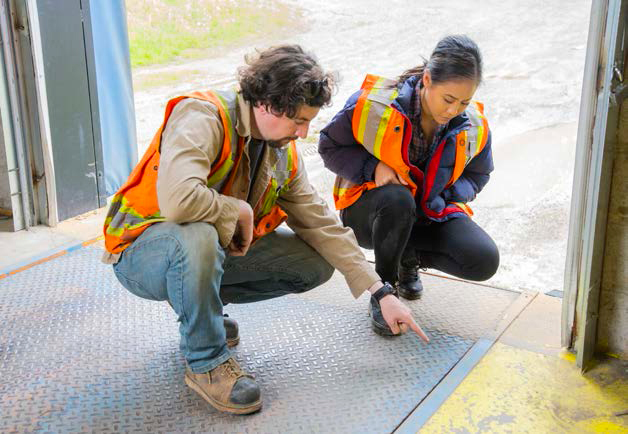 Two Workers Pointing to hazaard in plant floor