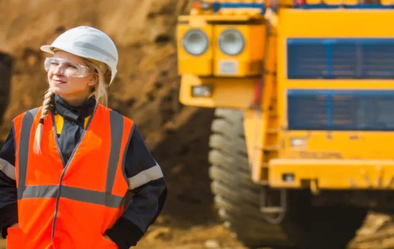 Two Workers in Hard Hats Walking Construction Site
