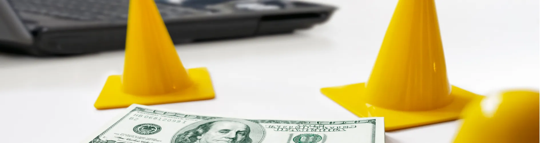 Safety cones surrounding a stack of money