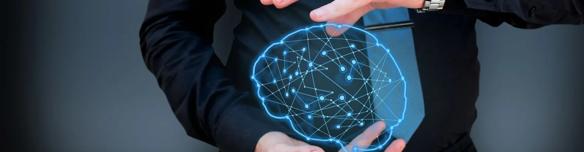 Man holding glowing polygonal brain on dark background. Artificial intelligence and mind concept