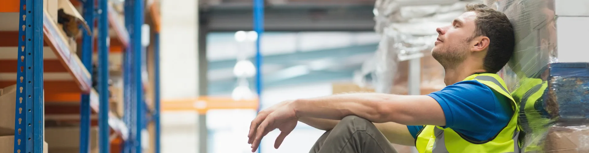 Exhausted worker sitting down on job