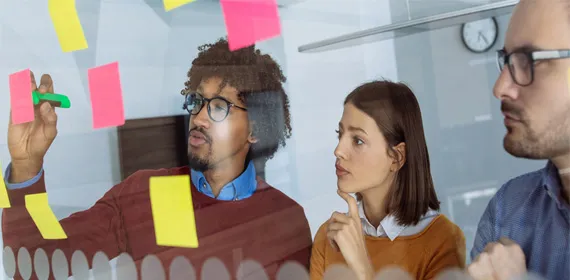 Businesspeople Planning Using a Clear Board