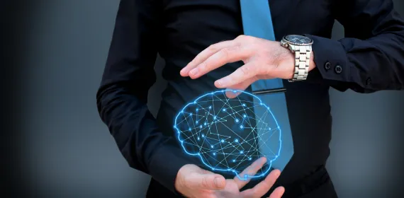 Man holding glowing polygonal brain on dark background. Artificial intelligence and mind concept